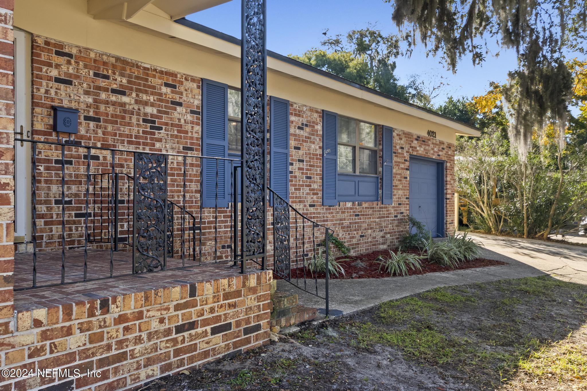 4021 Bess Road Jacksonville, FL 32277 - Photo 3 of 41 a view of a brick house with a yard