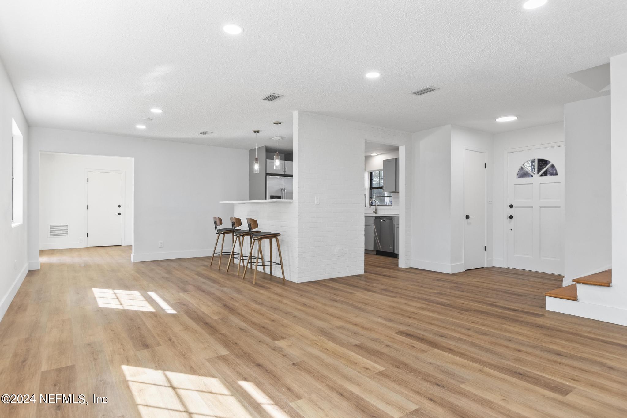 4021 Bess Road Jacksonville, FL 32277 - Photo 8 of 41 a view of empty room with wooden floor