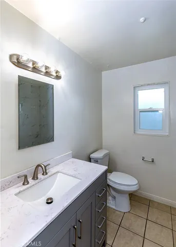 a bathroom with a sink a toilet and mirror