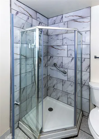 a bathroom with a shower and toilet