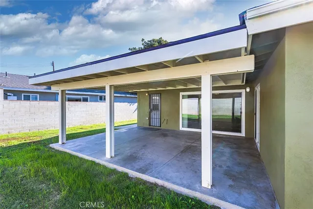 a view of an house with backyard porch and furniture