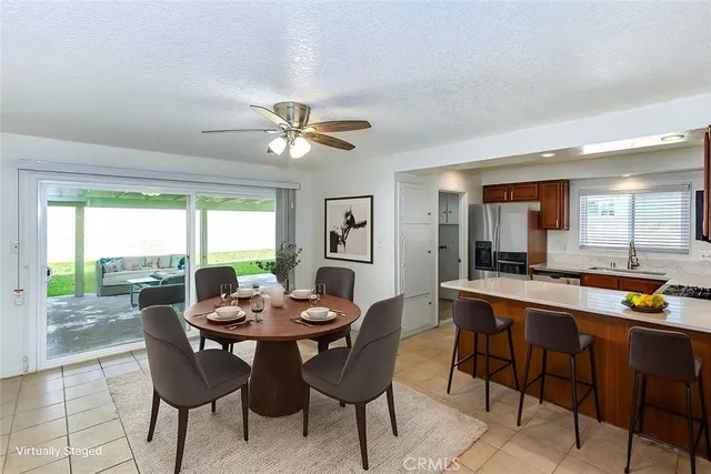 a dining room with furniture a rug and a large window