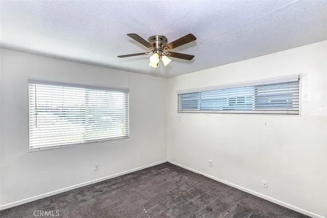 a view of a ceiling fan and a window