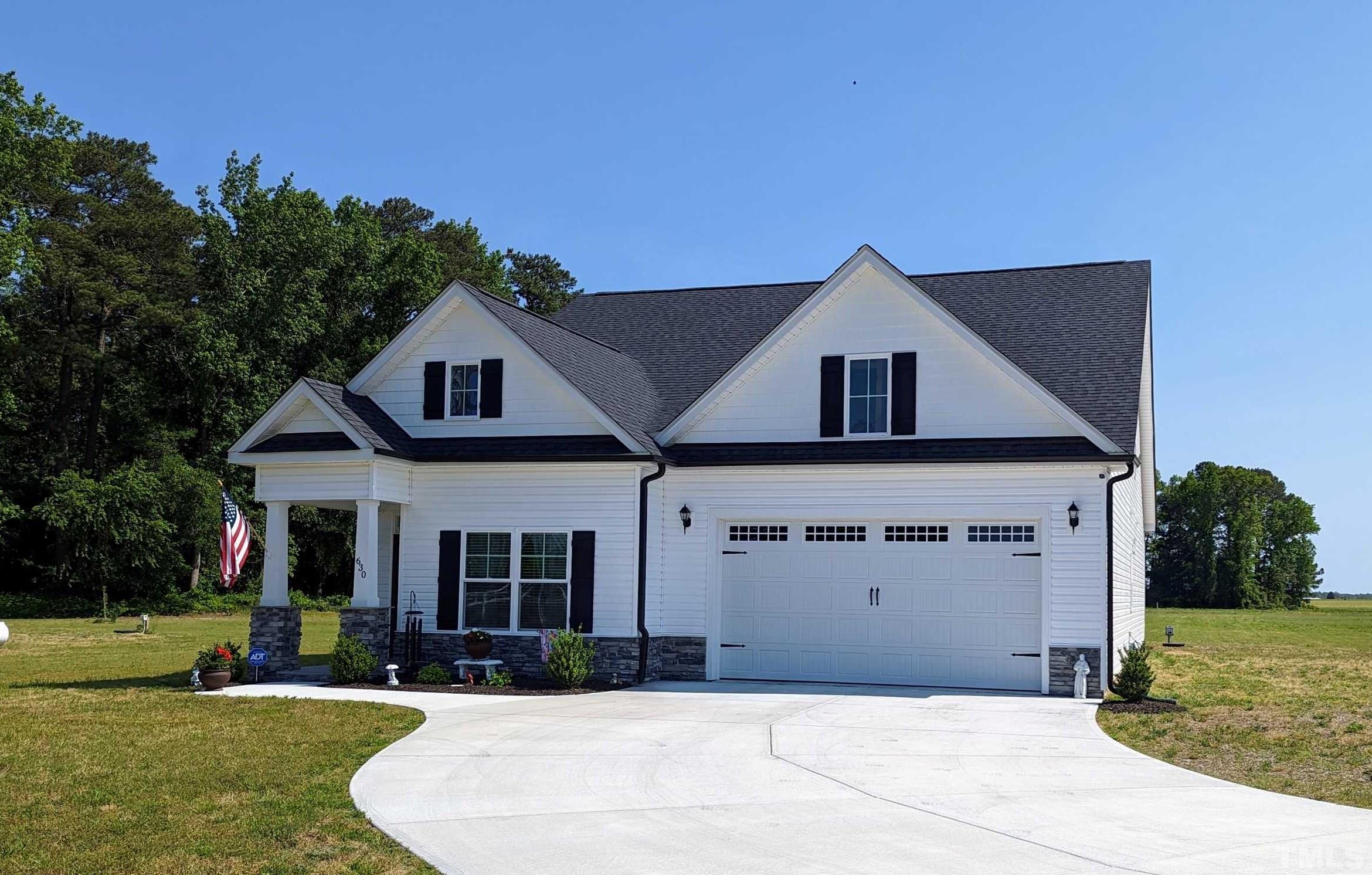 630 Ballance Road Fremont, NC 27830 - Photo 1 of 35 a front view of a house with a yard and garage