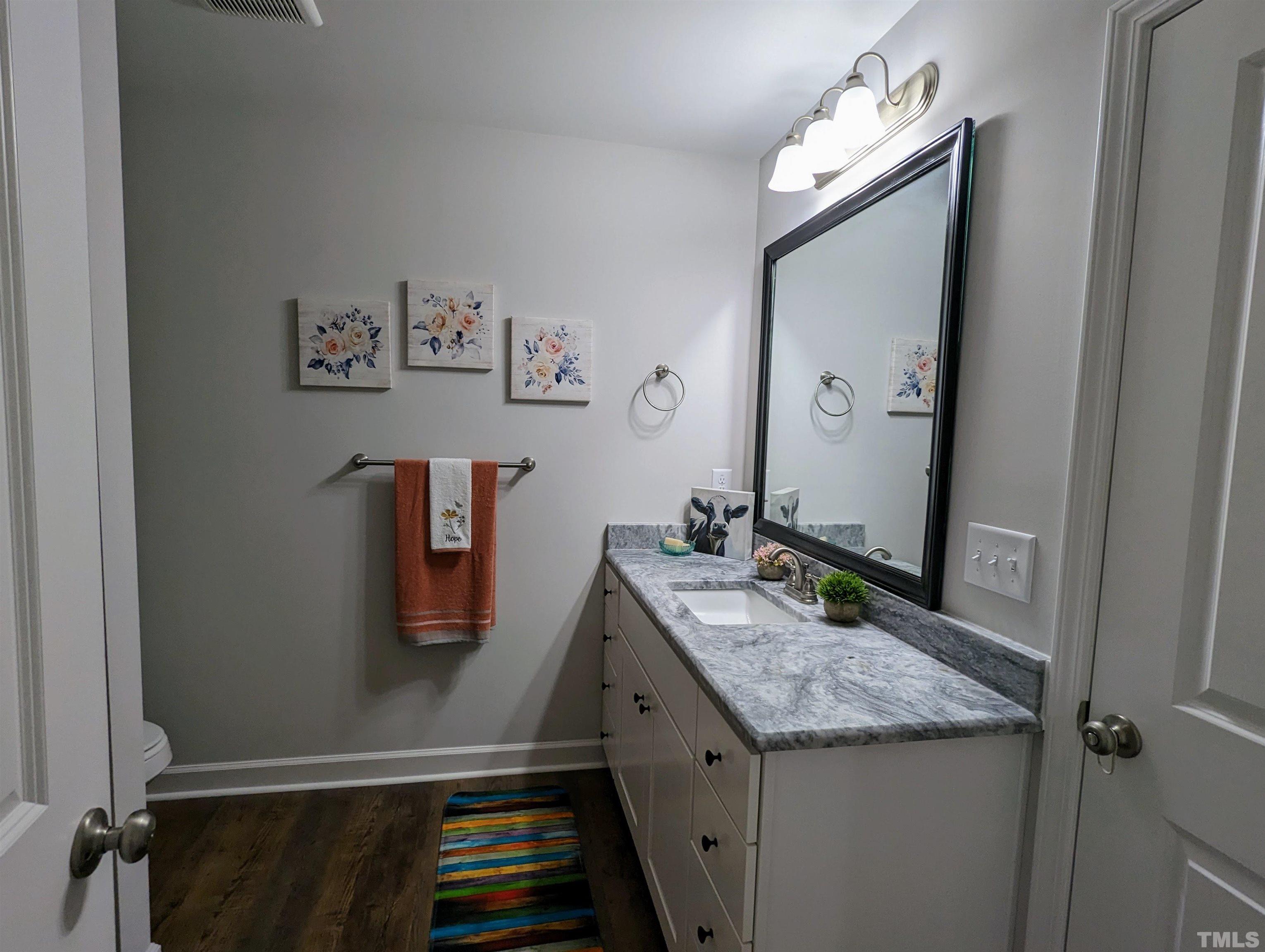 630 Ballance Road Fremont, NC 27830 - Photo 22 of 35 a bathroom with a granite countertop sink and a mirror