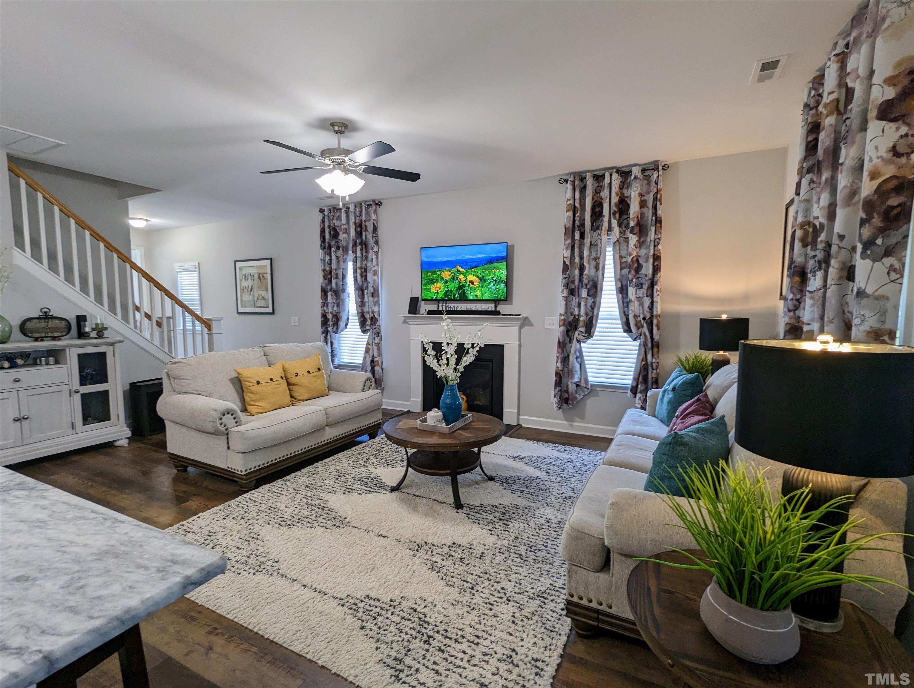 630 Ballance Road Fremont, NC 27830 - Photo 6 of 35 a living room with furniture a fireplace and a chandelier