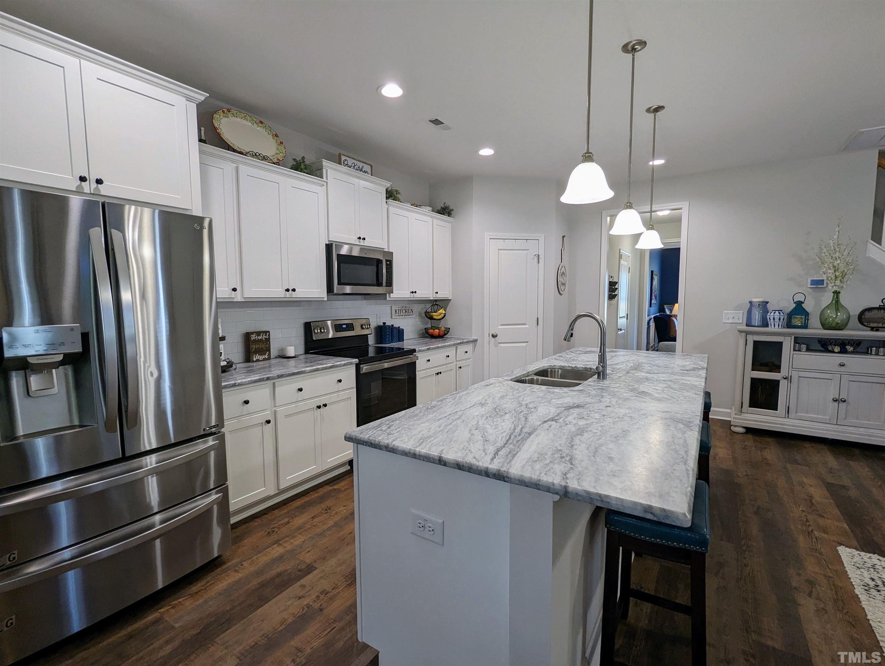 630 Ballance Road Fremont, NC 27830 - Photo 7 of 35 a kitchen with kitchen island a sink appliances and cabinets