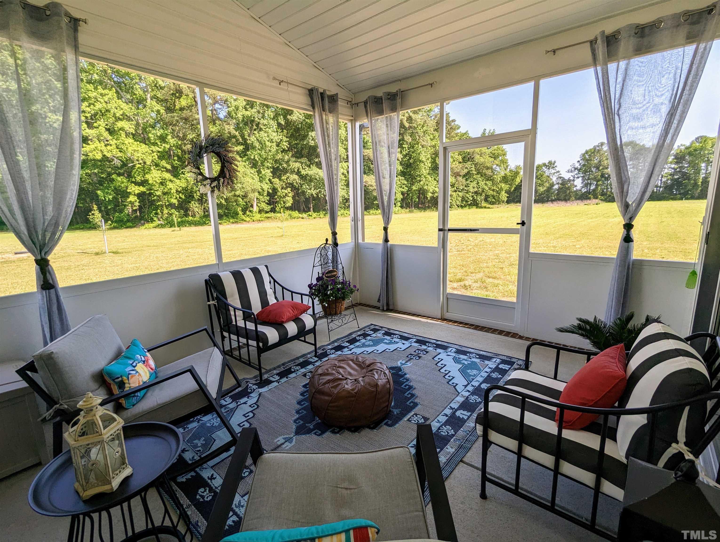 630 Ballance Road Fremont, NC 27830 - Photo 10 of 35 a living room with furniture and a floor to ceiling window