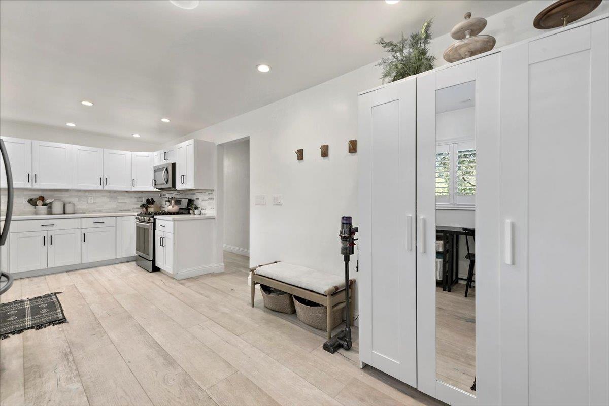 789 Cañada Road Woodside, CA 94062 - Photo 12 of 33 a kitchen with white cabinets and stainless steel appliances