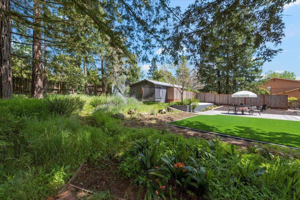 789 Cañada Road Woodside, CA 94062 - Photo 30 of 33 a backyard of a house with table and chairs