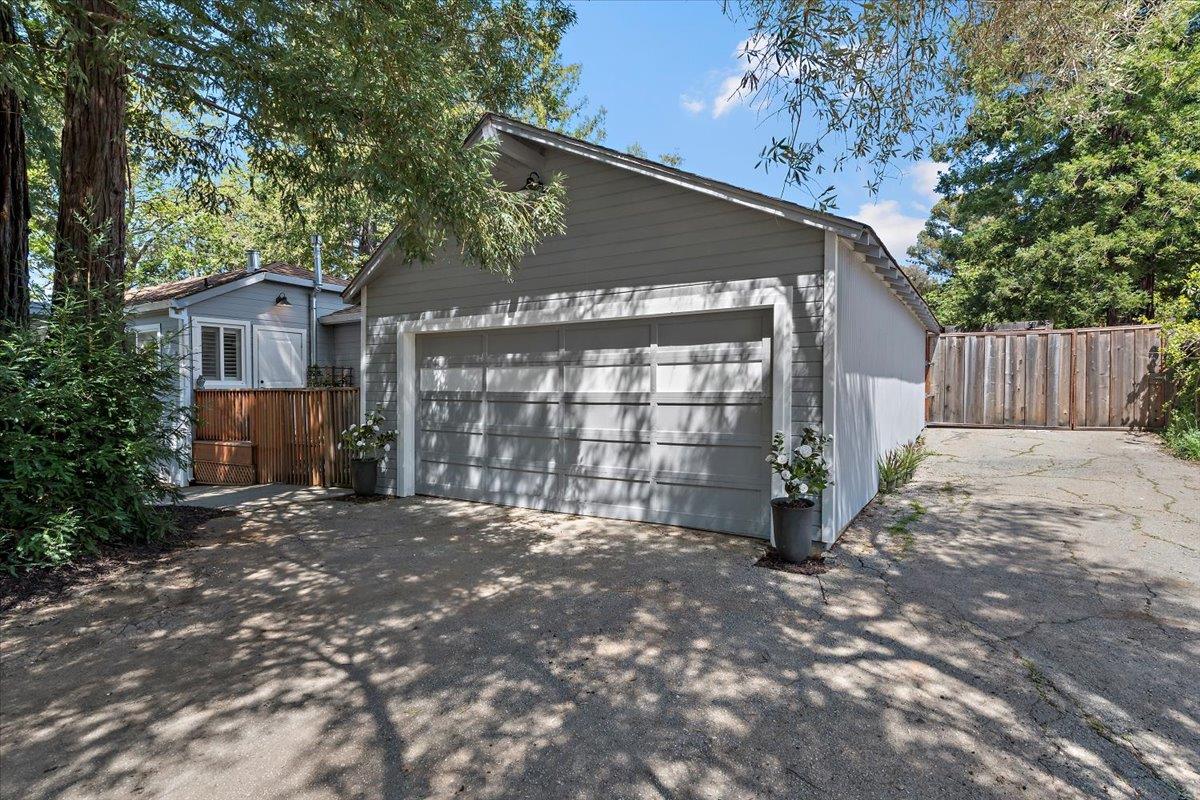 789 Cañada Road Woodside, CA 94062 - Photo 33 of 33 a view of a house with a large tree and wooden fence