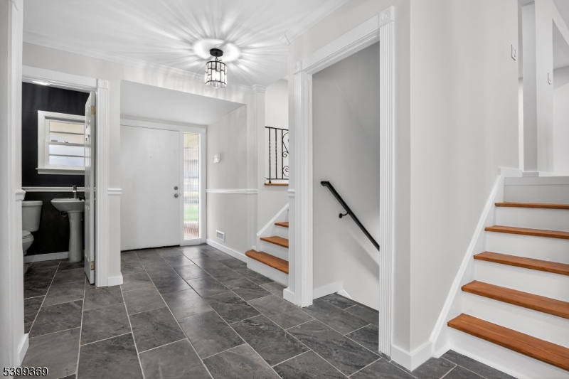 707 Warfield Road North Plainfield, NJ 07063 - Photo 13 of 28 wooden floor in a hall with an entryway and a ceiling fan