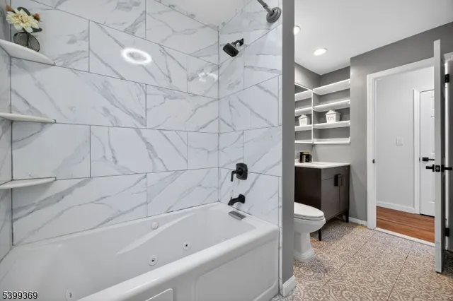 a bathroom with a bathtub and a shower