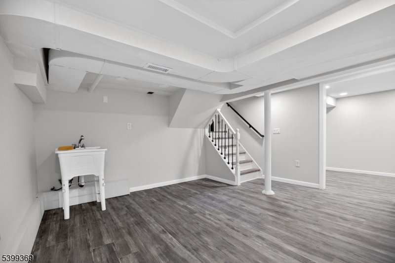 707 Warfield Road North Plainfield, NJ 07063 - Photo 22 of 28 a view of an empty room with wooden floor stairs and a way to ceiling window