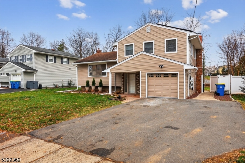 707 Warfield Road North Plainfield, NJ 07063 - Photo 3 of 28 a front view of a house with a yard and garage
