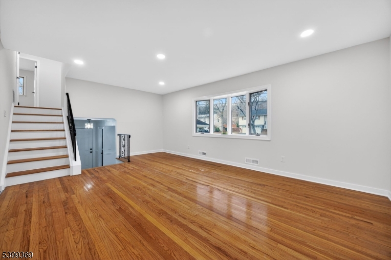 707 Warfield Road North Plainfield, NJ 07063 - Photo 10 of 28 a view of an empty room with wooden floor and a window