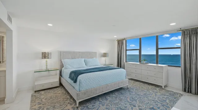 a bed room with a bed and a large window