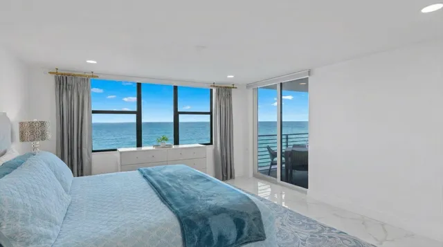 a large bedroom with a large bed and a large window