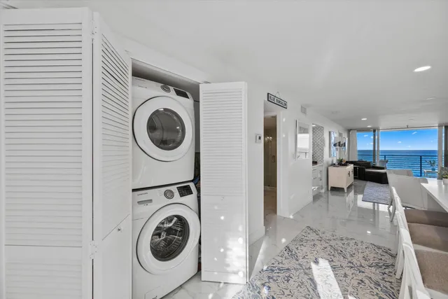 a view of swimming pool with building and ocean view