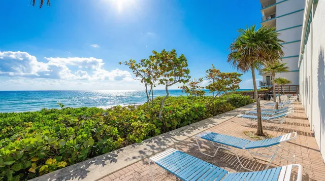 a view of a balcony with floor to ceiling windows with wooden floor