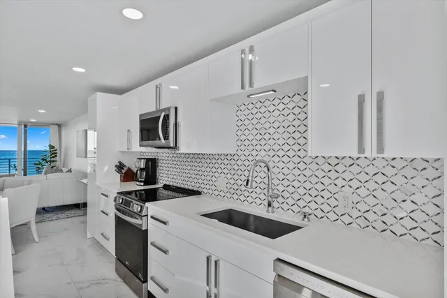 a kitchen with a sink stove and microwave