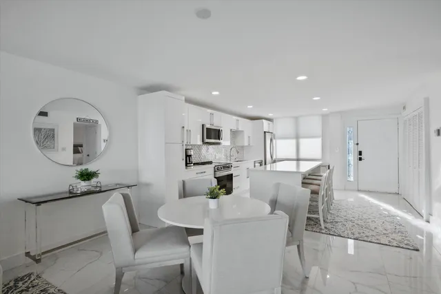a living room with furniture a dining table and kitchen view