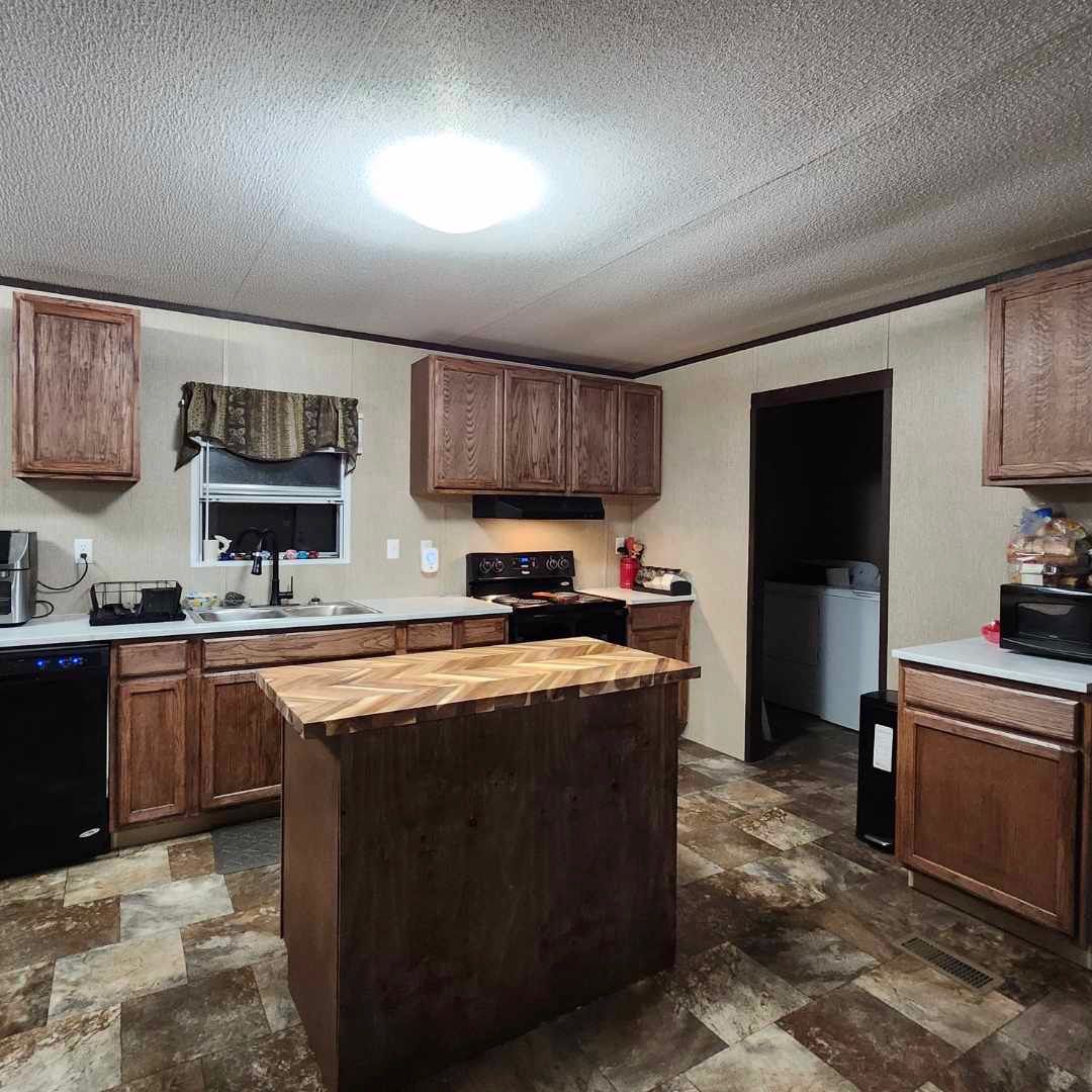 357 Duchess Pass Kyle, TX 78640 - Photo 4 of 18 a kitchen with stainless steel appliances granite countertop a stove a sink and a refrigerator