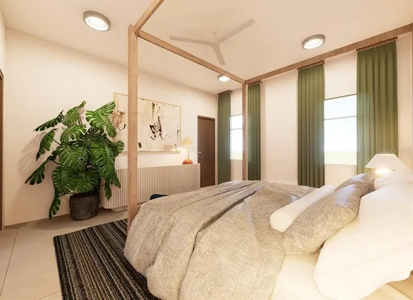 a bedroom with a bed and a potted plant