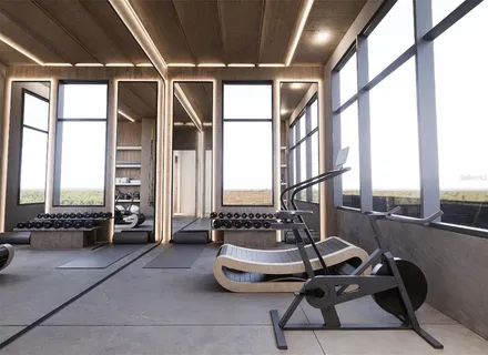 a room with gym equipment and a large window