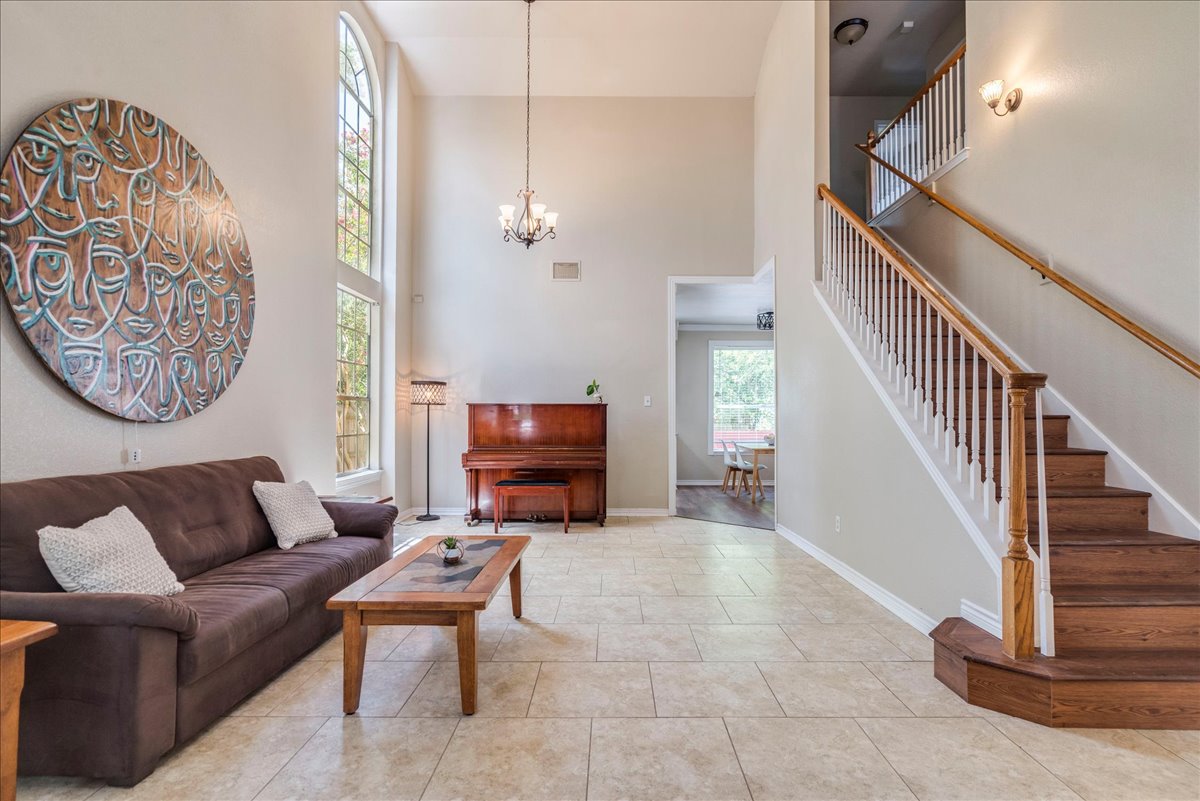 9300 Tea Rose Trail Austin, TX 78748 - Photo 7 of 33 A sun-filled living area features soaring ceilings and tile flooring.