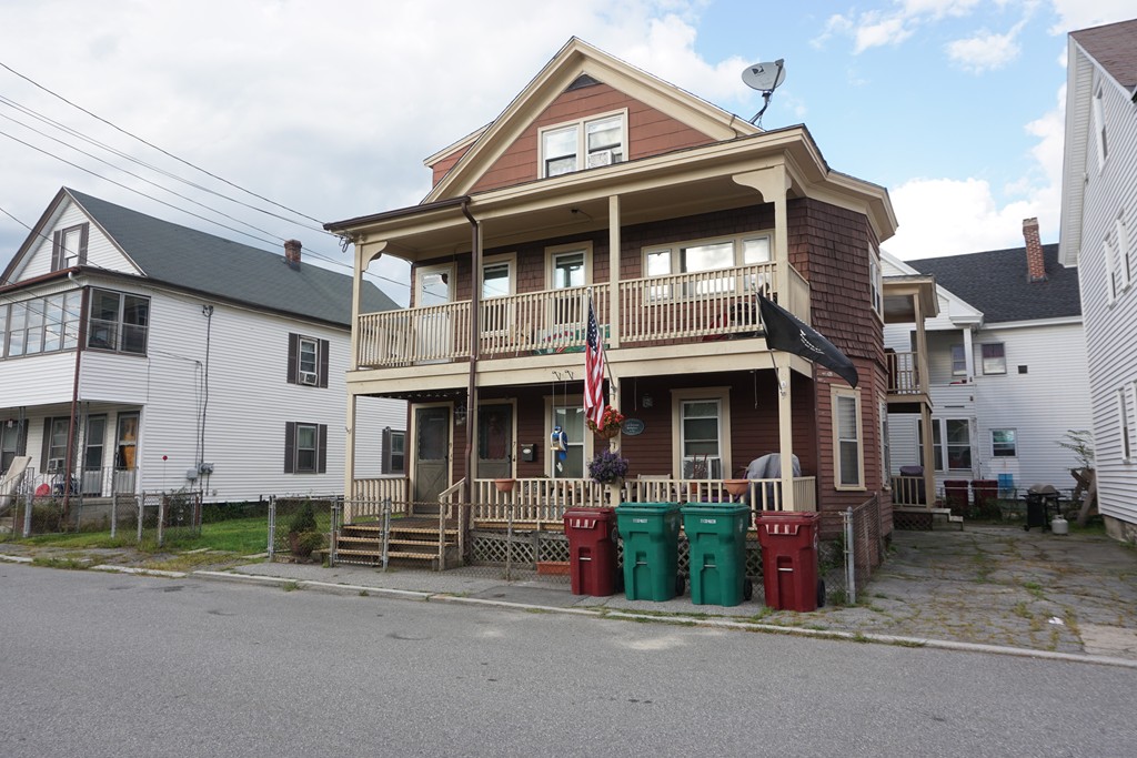 7-9 Lupine Road Lowell, MA 01850 - Photo 2 of 5 a front view of a house with board