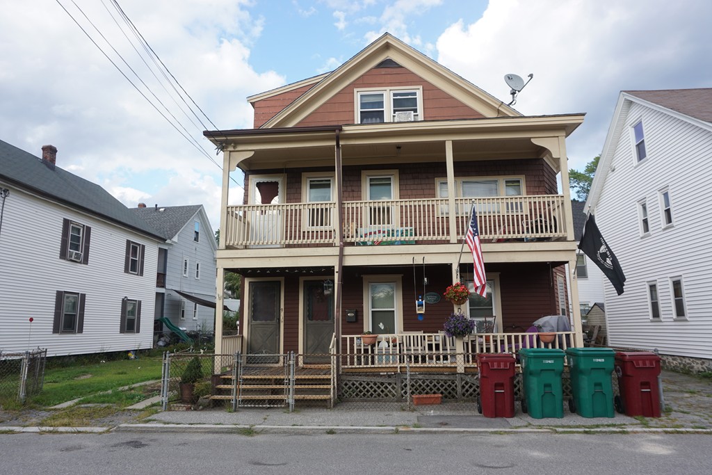7-9 Lupine Road Lowell, MA 01850 - Photo 3 of 5 a front view of a house with a yard