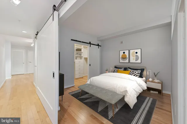 a bedroom with a bed and a chandelier