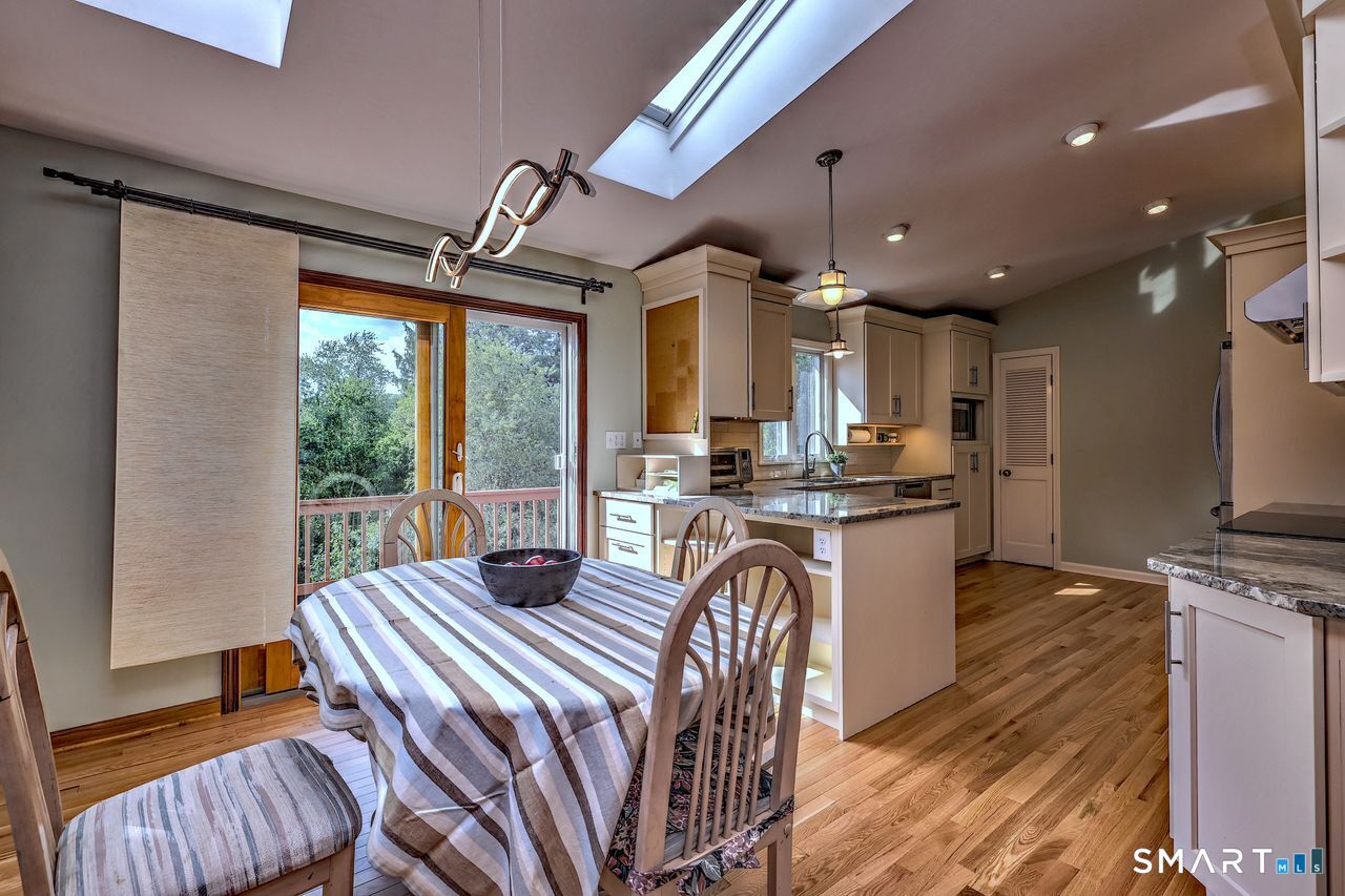 90 Brook Hill Road Hamden, CT 06514 - Photo 15 of 38 Kitchen is open to the living room with fire place, bay window, hardwood floor and skylight