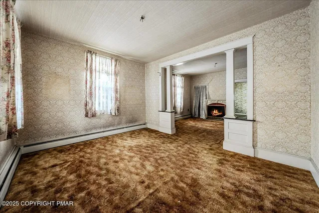 a view of a big room with windows and wardrobe