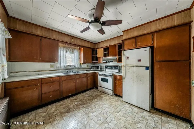 a kitchen with refrigerator a sink and cabinets