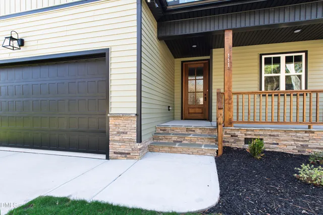 a kitchen with stainless steel appliances a sink a stove a refrigerator cabinets and wooden floor