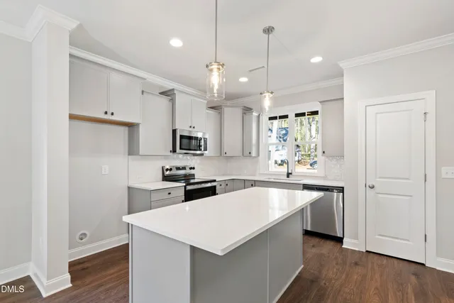 a kitchen with a sink stove and microwave