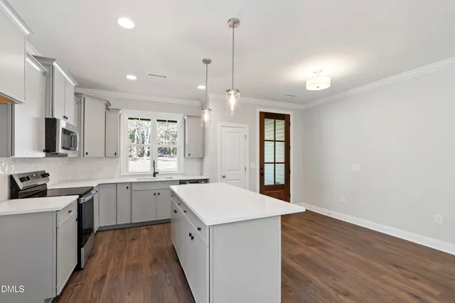 an empty room with windows and a fireplace