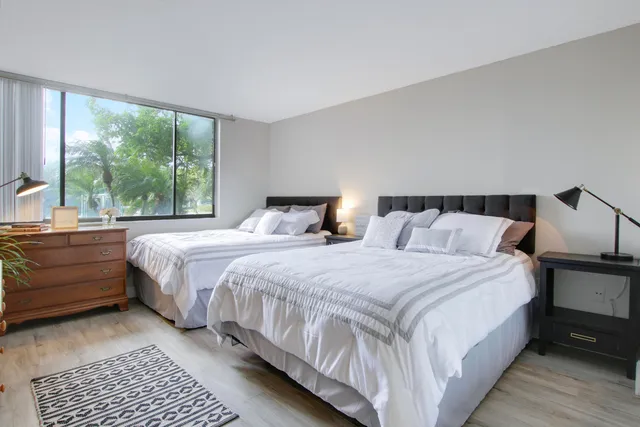 a bedroom with a bed and a large window