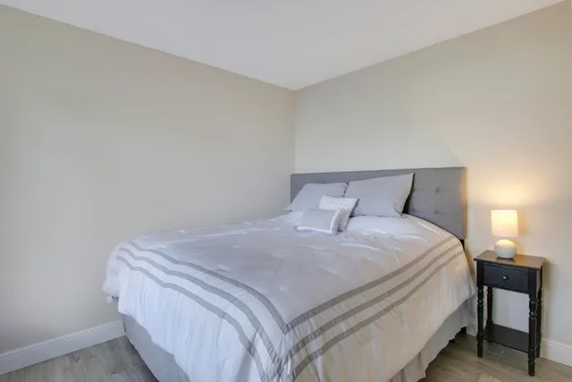 a bedroom with a bed and a lamp