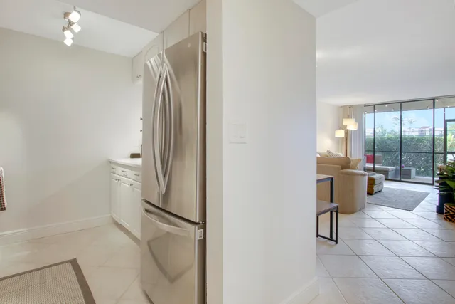 a kitchen with a refrigerator and a sink