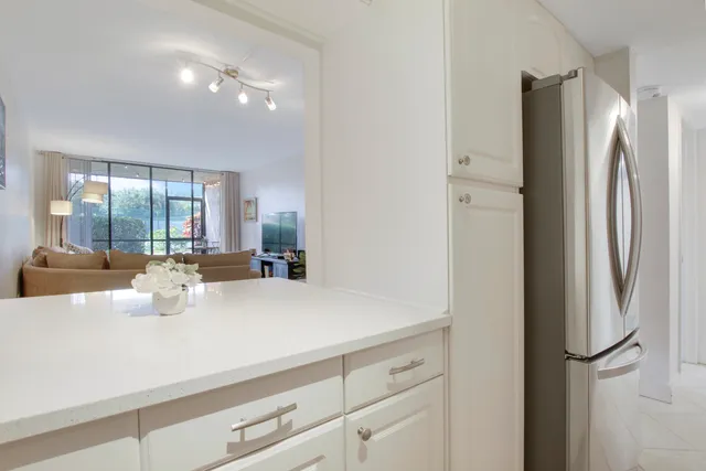 a kitchen with stainless steel appliances a refrigerator and cabinets