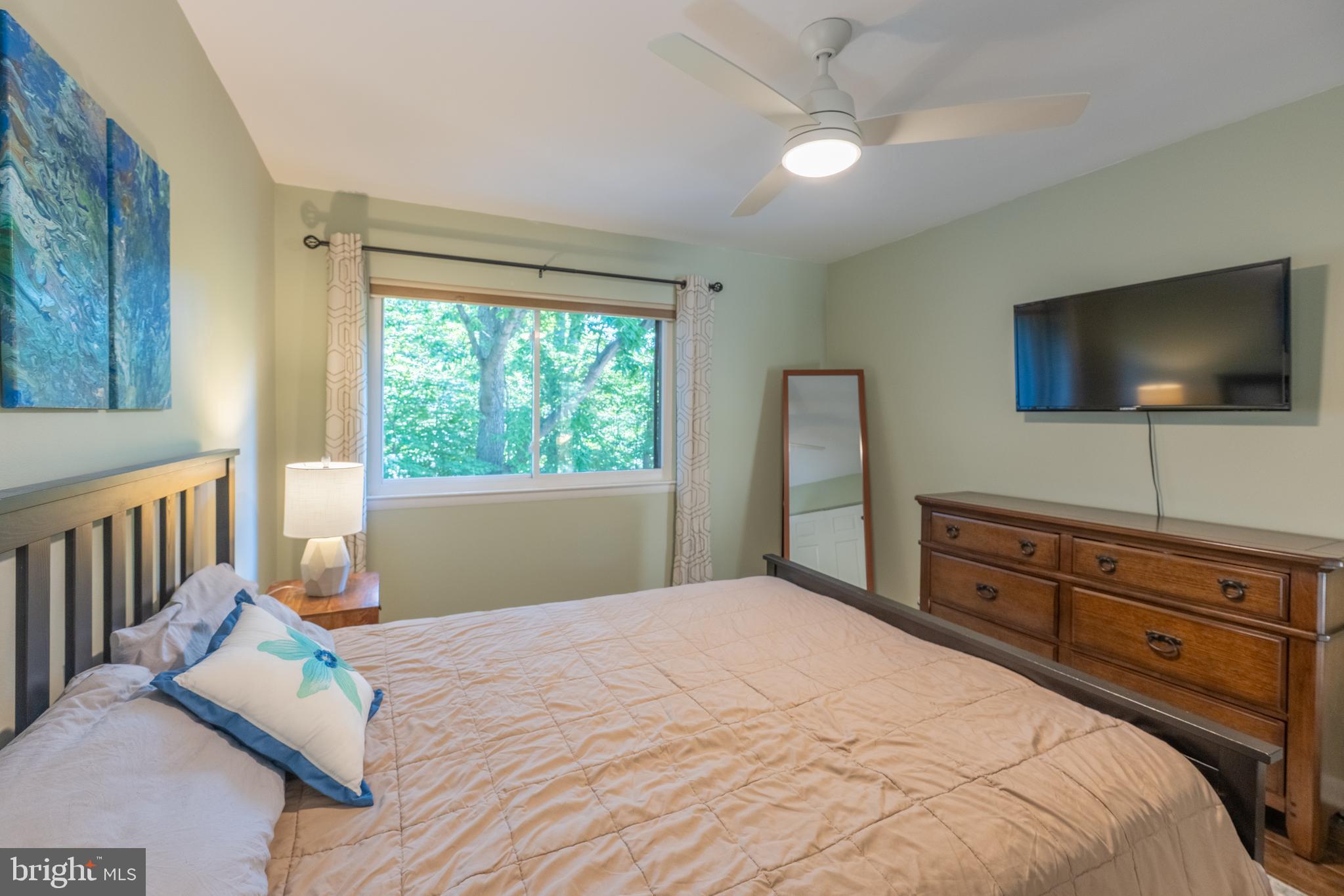 11917 Barrel Cooper Court Reston, VA 20191 - Photo 26 of 59 a bedroom with a bed and a flat screen tv