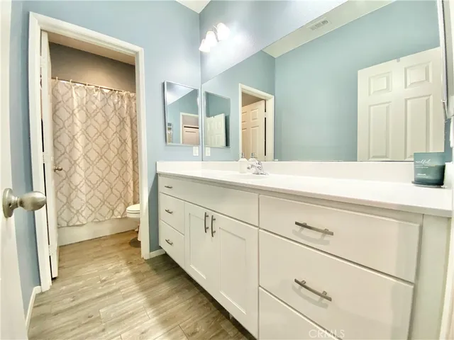 a bathroom with a double vanity sink and mirror