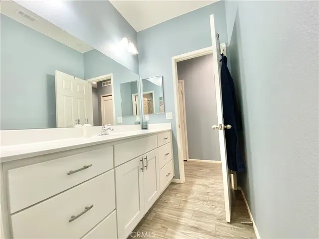 a view of a hallway with wooden floor fireplace and living room