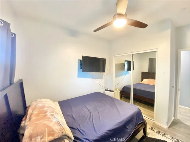 a large bed sitting in a bedroom next to a window