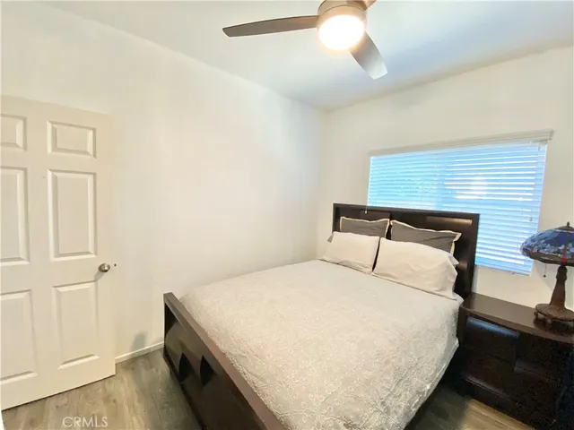 a bedroom with a bed and a night stand