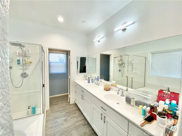a bedroom with a bed and a flat tv screen on wall