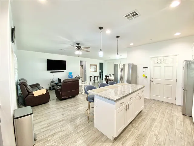a view of a a dining room with furniture window and wooden floor